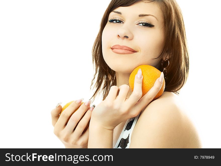 Beautiful happy young brunette woman with oranges in her hands