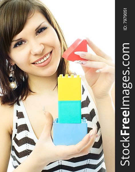 Beautiful Young Woman Building A Toy House