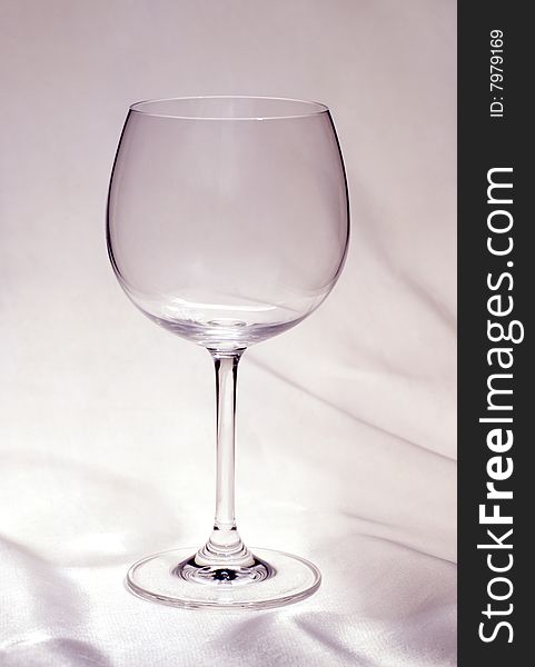 Empty glass of wine on a white cloth