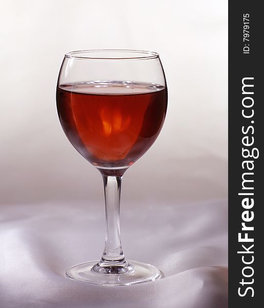 Glass of red wine on a white cloth