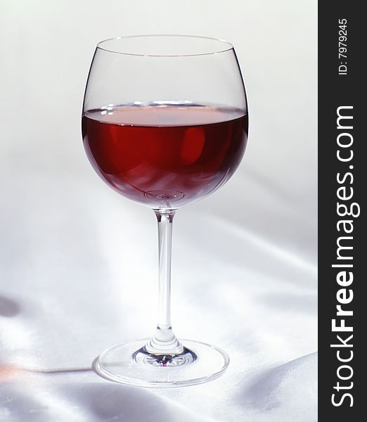 Glass of red wine on a white cloth