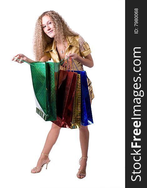 The young beautiful girl with purchases in colour packages during shopping on a white background