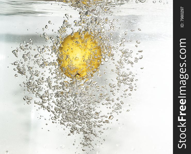 Lemon is dropped into fresh water.