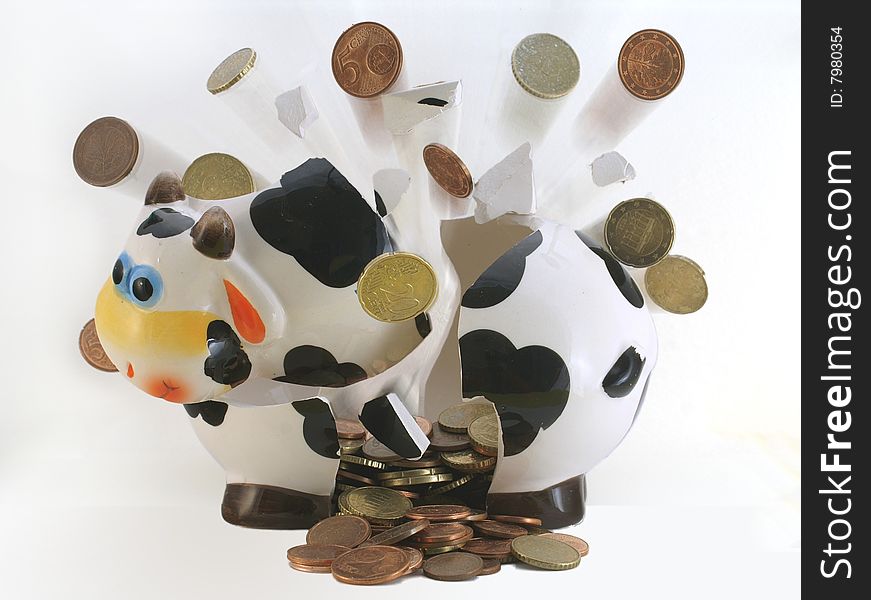 The broken money box with the scattered coins. The broken money box with the scattered coins.