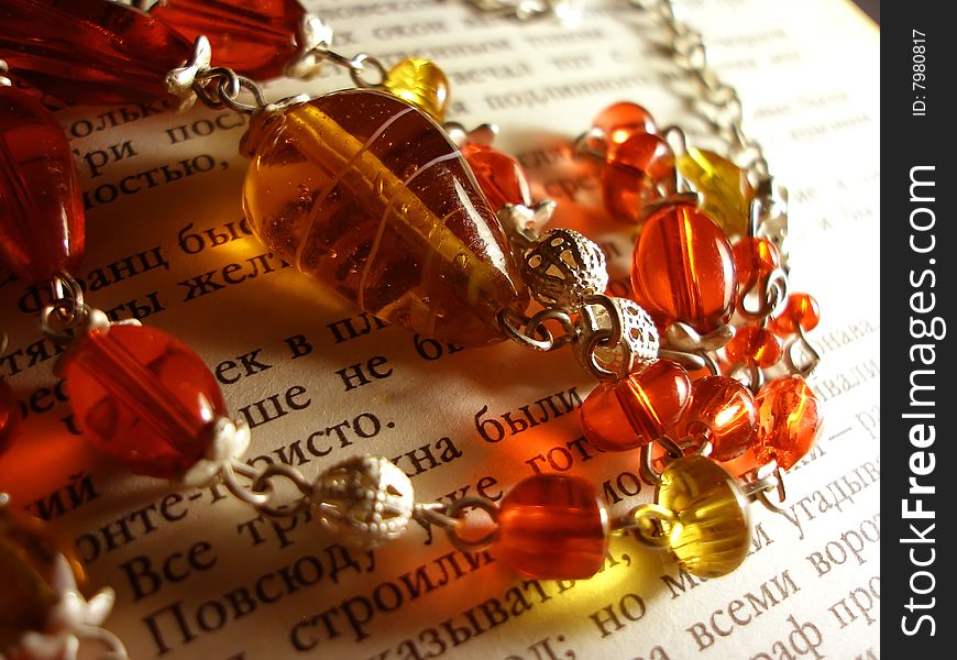 The red & yellow necklace on the book page. The red & yellow necklace on the book page