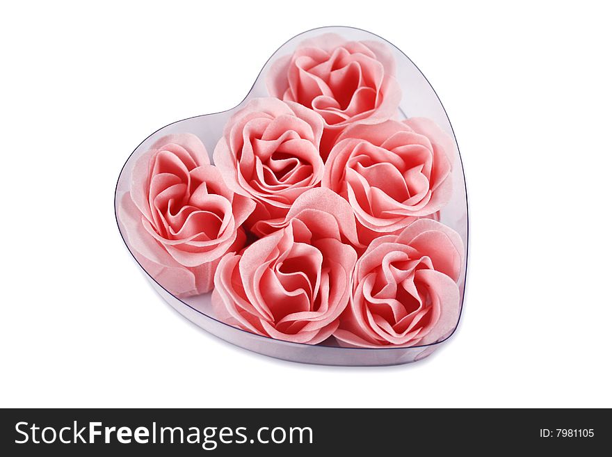 Pink roses in a heart shape, isolated on white background