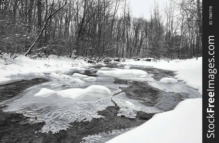 Tranquil winter stream after a fresh snowfall