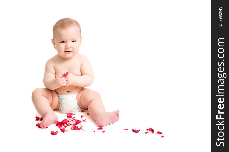 Baby playing with red petals