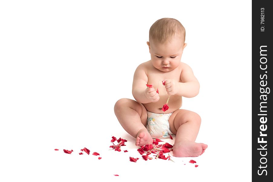 Baby playing with red petals