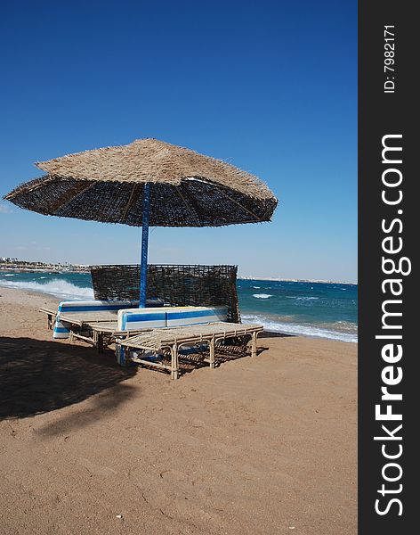 Umbrella on the beach with sea behind