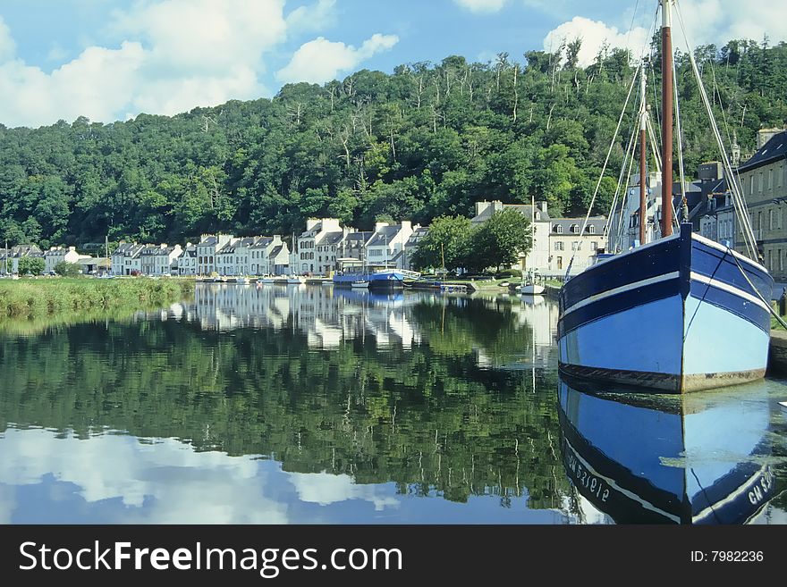 Sailing ship in the harbor of a small fishing village. Sailing ship in the harbor of a small fishing village