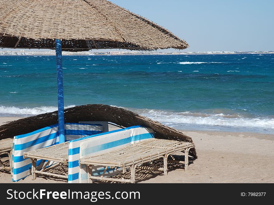 Umbrella on the beach with sea behind