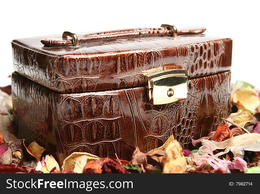 Brown crocodile skin box and flowers. Brown crocodile skin box and flowers