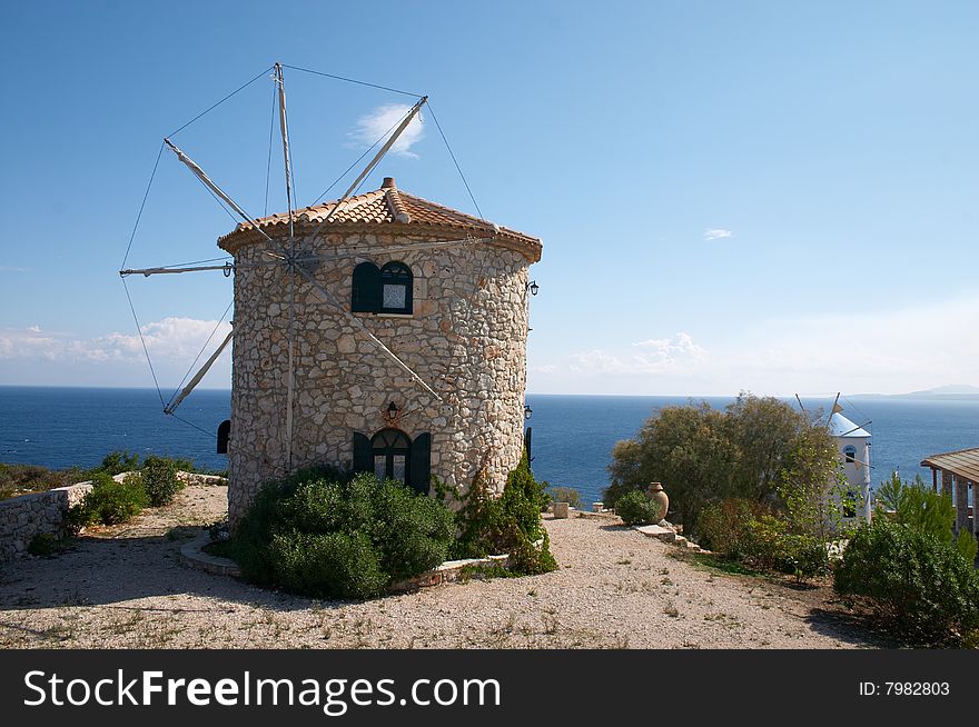 Windmills on hill over sea in Greece