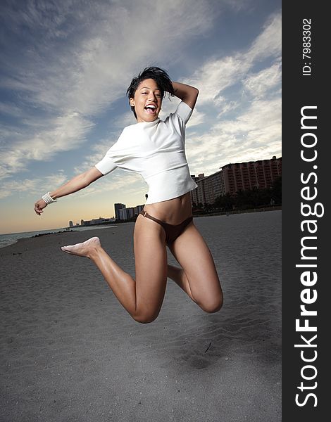 Young woman on the beach jumping for joy. Young woman on the beach jumping for joy