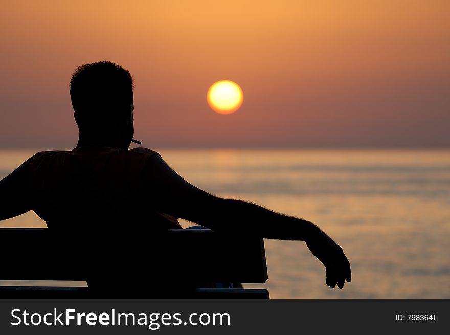 Male sitting on bench and relaxing. Male sitting on bench and relaxing