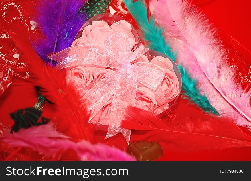 Valentines box and color feathers  locating on the red. Valentines box and color feathers  locating on the red.