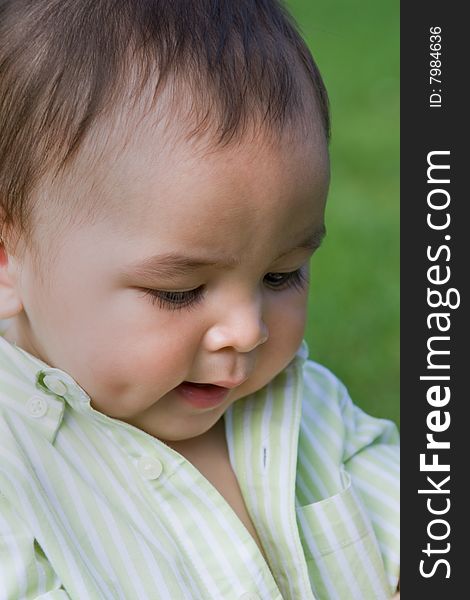 Closeup portrait of a precious little boy sitting outside. Closeup portrait of a precious little boy sitting outside