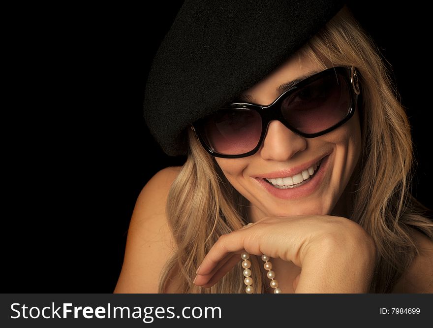 Beautiful portrait of a blond woman wearing sunglasses, hat, and pearls. Beautiful portrait of a blond woman wearing sunglasses, hat, and pearls.