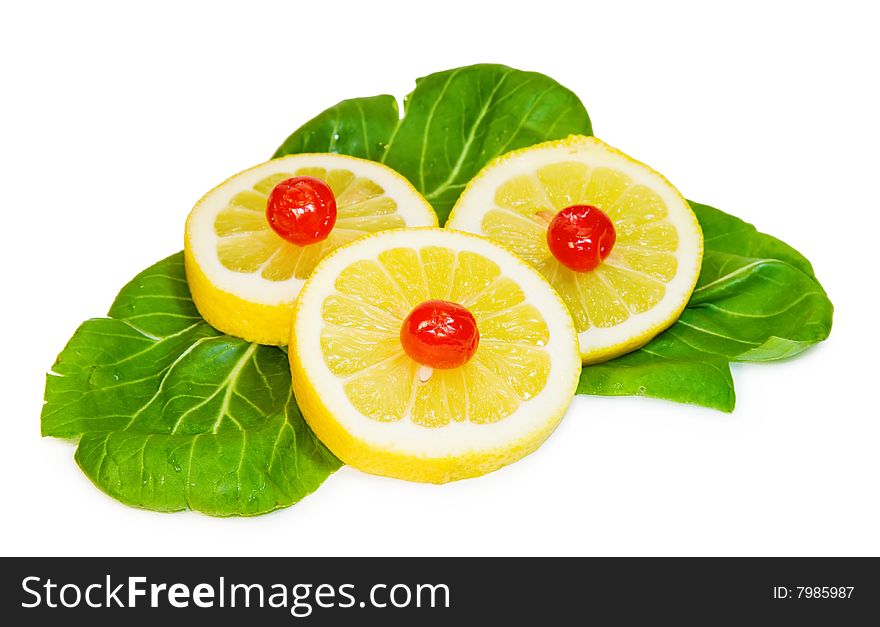 Sweet and sour - lemon slices and red cherries on green leaf. Isolated on white. Clipping path available at large size. Sweet and sour - lemon slices and red cherries on green leaf. Isolated on white. Clipping path available at large size.