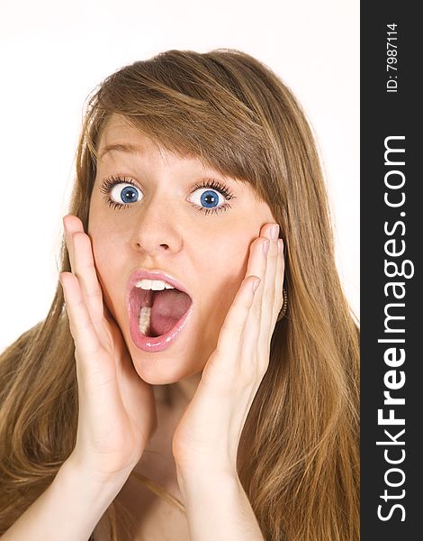 Portrait of a beautiful Caucasian woman holding her face in astonishment. Isolated over white