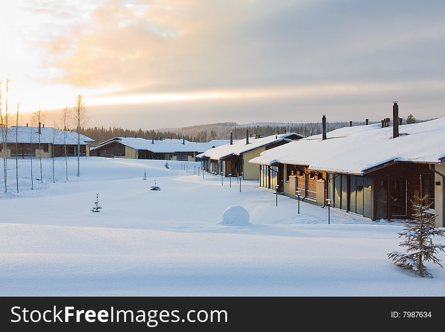 Winter landscape with cottages covered by snow. Sunset. Winter landscape with cottages covered by snow. Sunset.