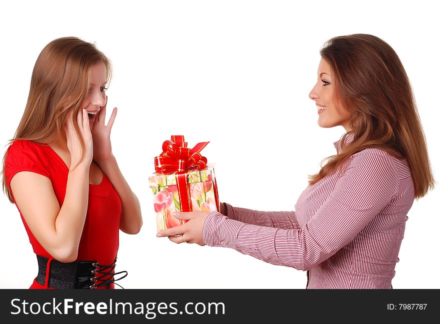 Two beautiful women with gift at white background. Two beautiful women with gift at white background