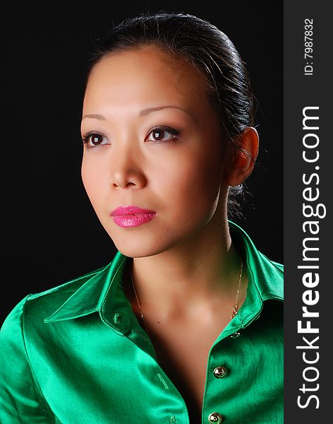 Portrait of a beautiful young woman in green shirt