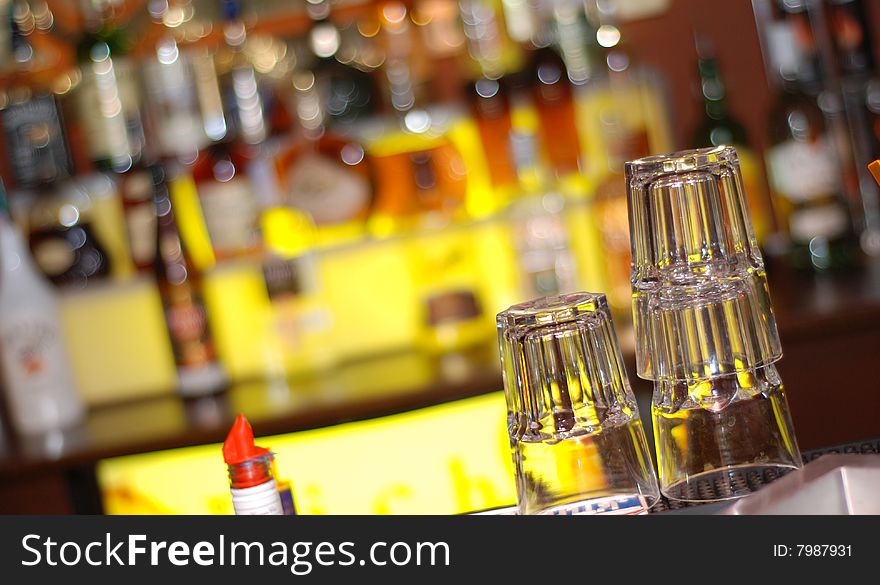 Illuminated bar counter with empty faceted glass. Illuminated bar counter with empty faceted glass