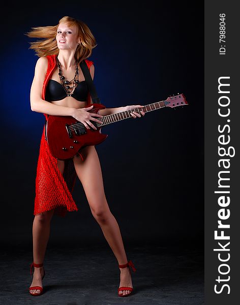 Portrait of a young woman with red electric guitar. Portrait of a young woman with red electric guitar