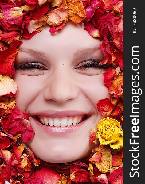 Portrait of beautiful woman with dried roses around her face. Portrait of beautiful woman with dried roses around her face