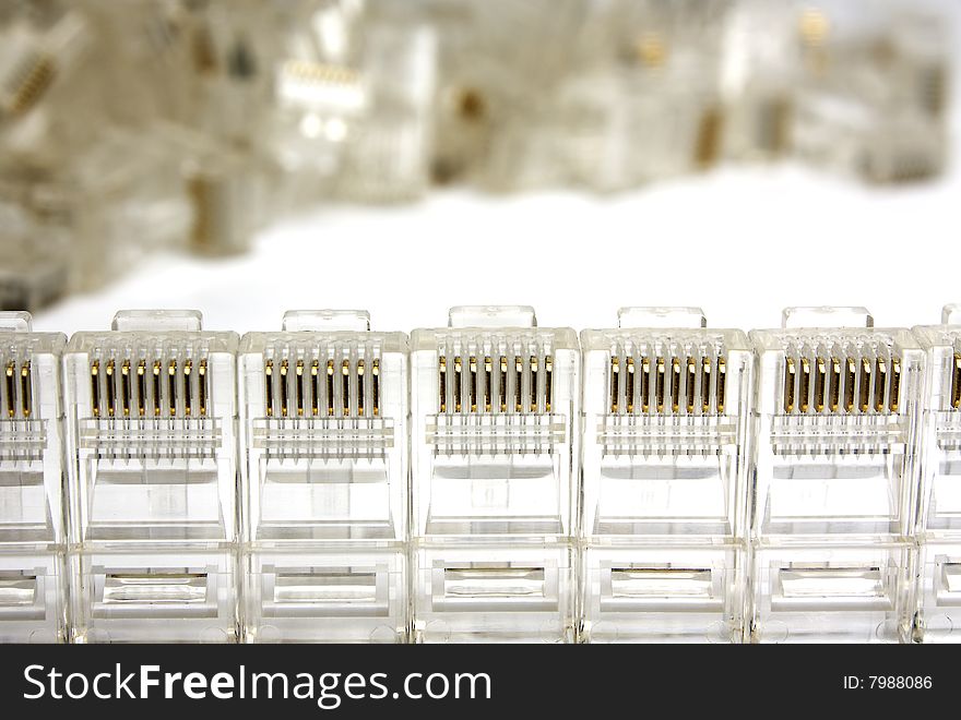 Plugs rj45 stay in a row. Heap of plugs on a background.