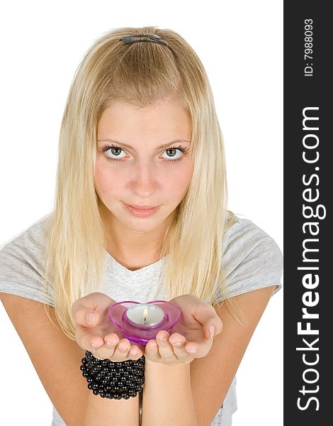 Young blonde girl offerind a heart-style candle isolated over white. Young blonde girl offerind a heart-style candle isolated over white