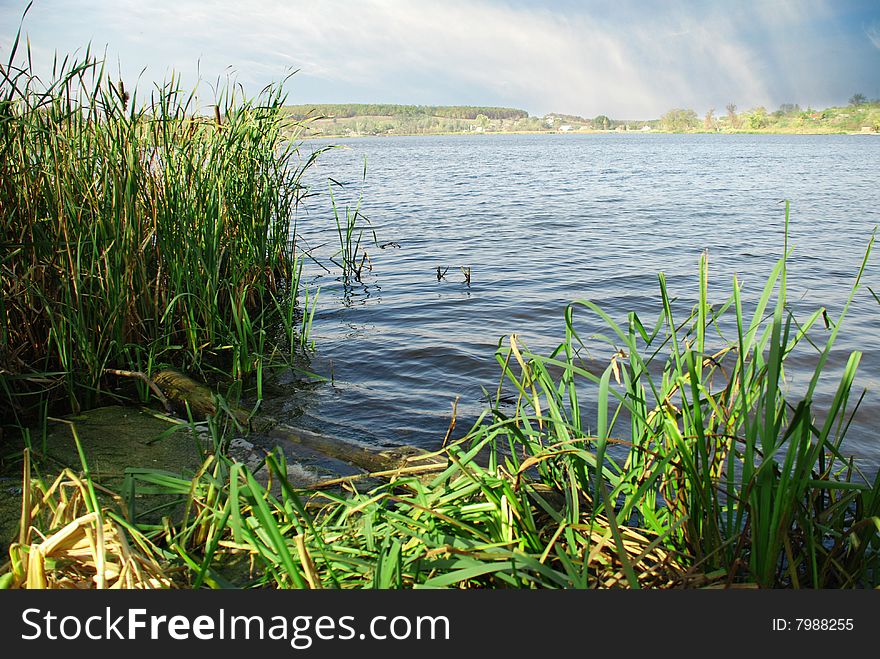 Landscape with river and blue cloudy sky. Landscape with river and blue cloudy sky