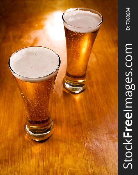 Beer glasses on wood background, selective focus. Beer glasses on wood background, selective focus