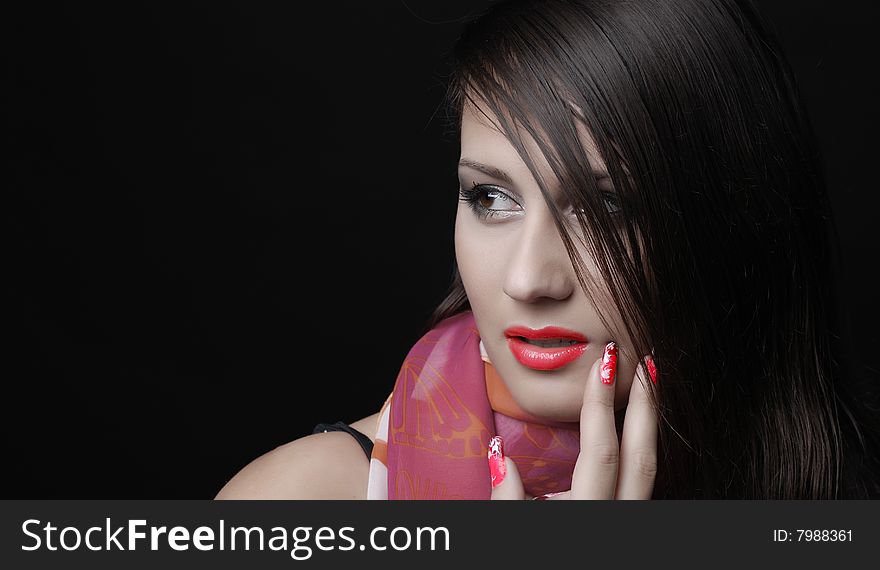 Beautiful brunet woman in red scarf at black background. Beautiful brunet woman in red scarf at black background