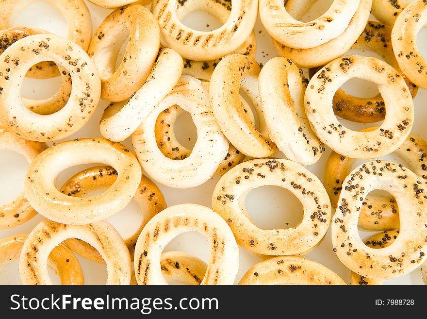 Bread-rings with poppyseeds on white ground