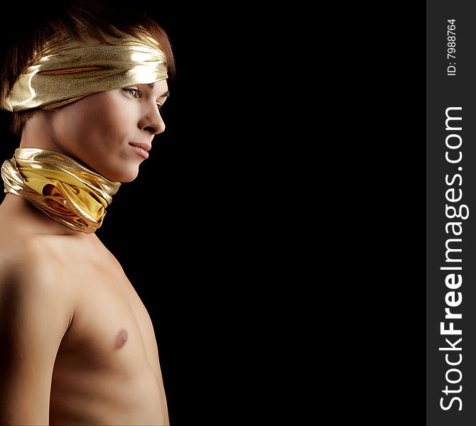 Glamour Man with Gold Bandage. Isolated on Black Background