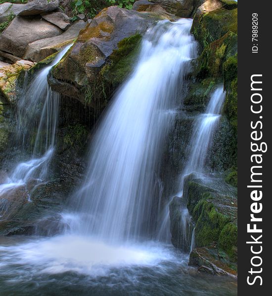 On a photo mountain river, stone with moss. Ukraine, Karpaty