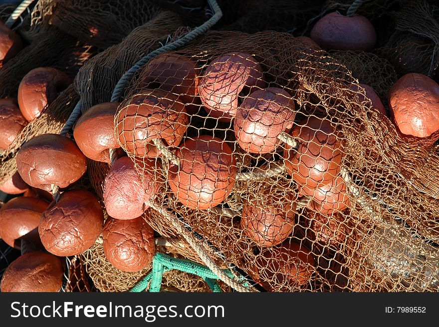 Detail of a fishing net left on the ground in the harbour