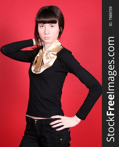 A studio portrait of a standing girl. A studio portrait of a standing girl