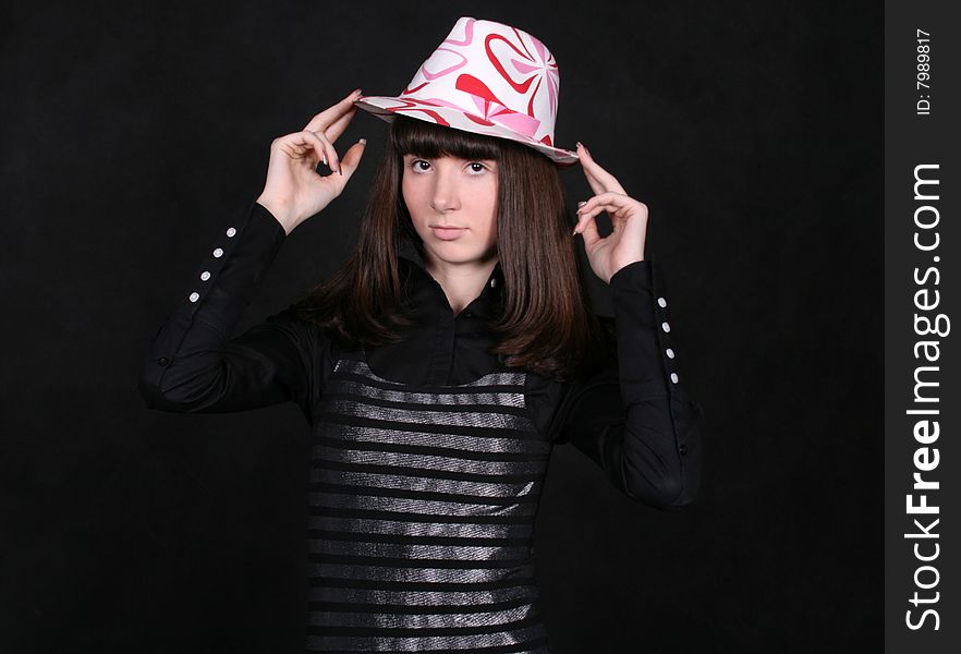 A girl standing in studio in a nice hat. A girl standing in studio in a nice hat