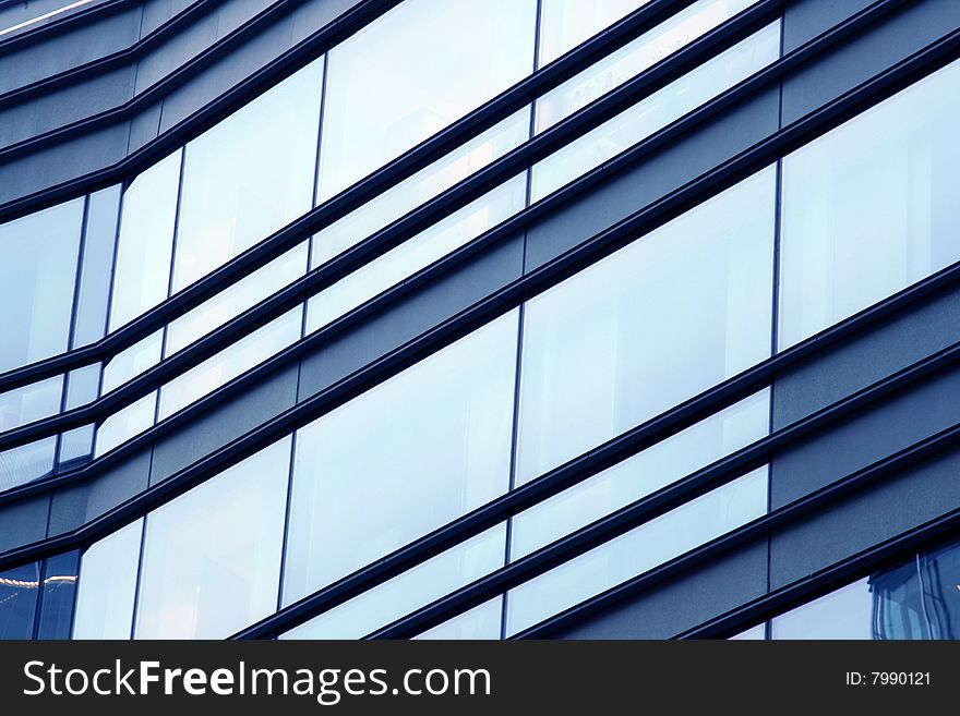 Side detail of corporate building windows with reflections