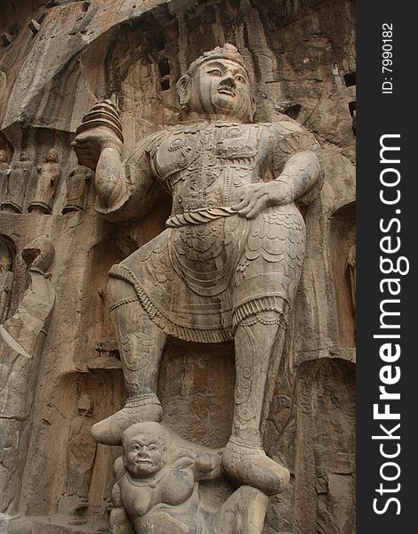 A sculpture of Heavenly King with a Pagoda in Hand in Longmen Grottoes