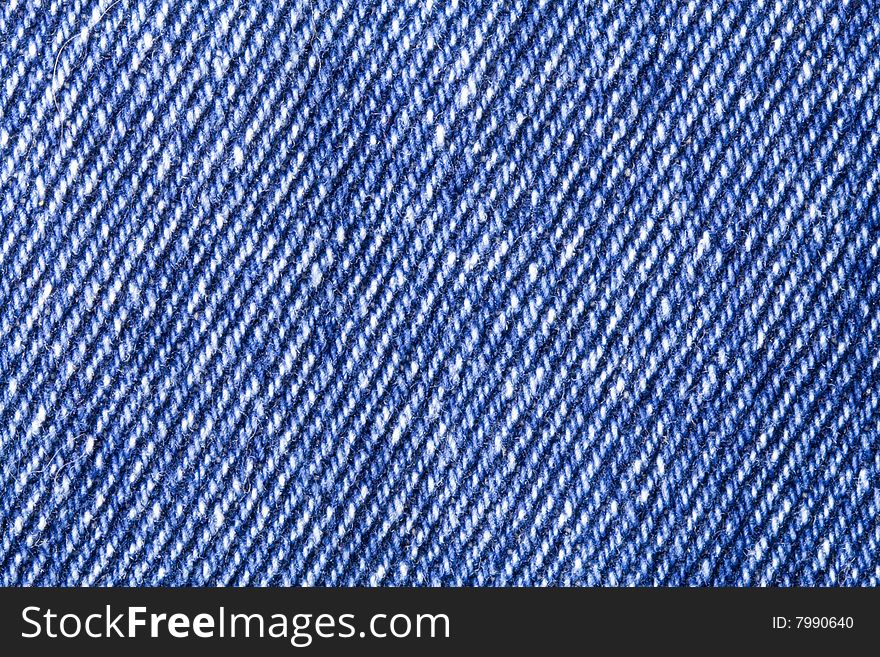 A close-up of the texture of blue jeans fabric. A close-up of the texture of blue jeans fabric