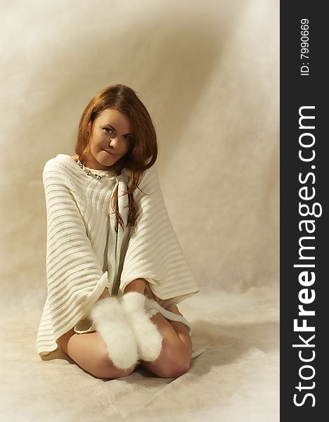 The modest girl in a white sweater and fluffy mitten. The modest girl in a white sweater and fluffy mitten