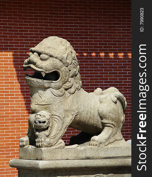 In front of the ancient building stone lions