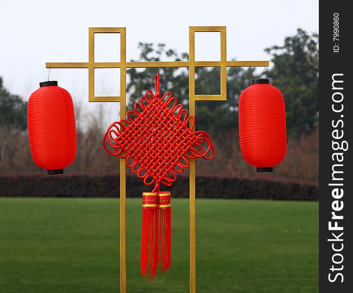 Chinese knot and lanterns on a lawn, chinese traditional mascot. Chinese knot and lanterns on a lawn, chinese traditional mascot