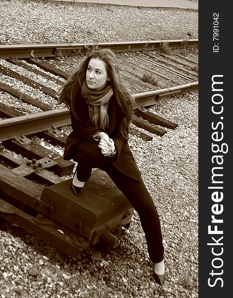 A girl sitting near railroad. A girl sitting near railroad
