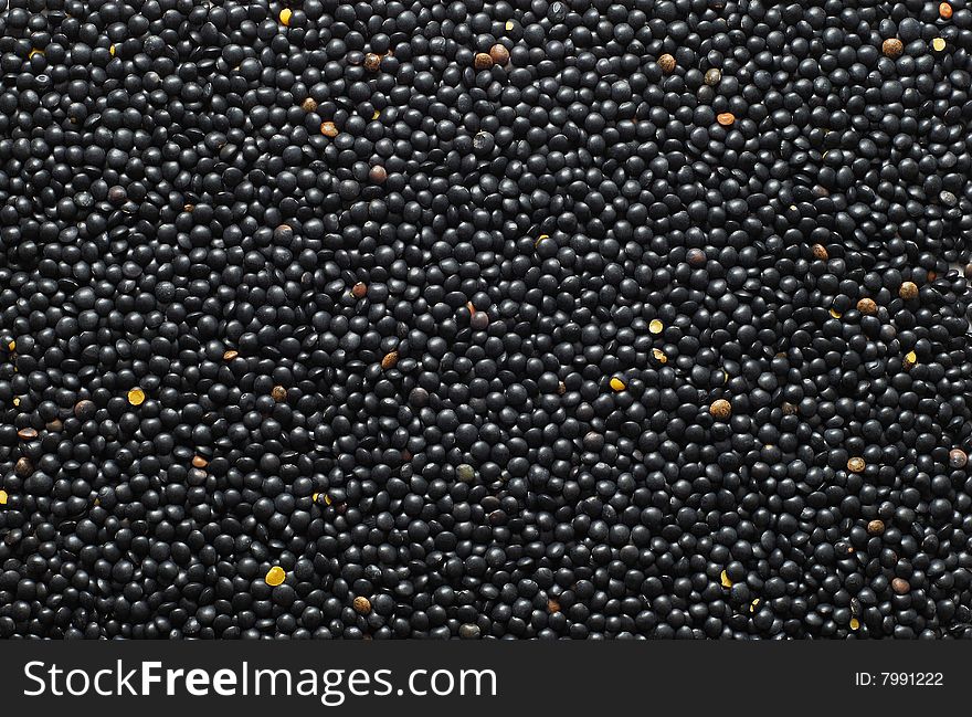 Black lentil background. food background